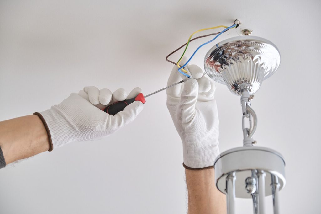 electrician repairing lighting fixture